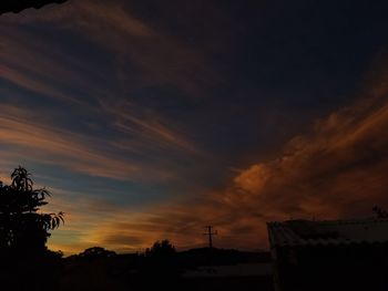 Low angle view of silhouette trees against sky at sunset