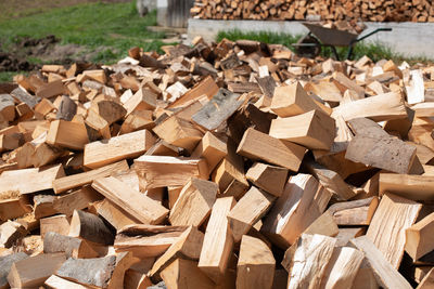 High angle view of stack of firewood in field