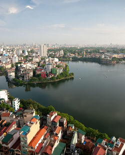 High angle view of buildings and river against sky