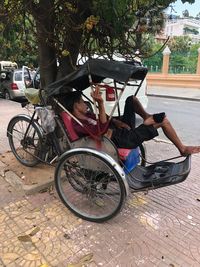 People sitting on street in city