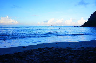 Scenic view of sea against blue sky