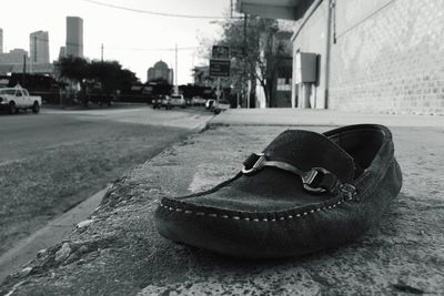 Close-up of lost shoe on sidewalk