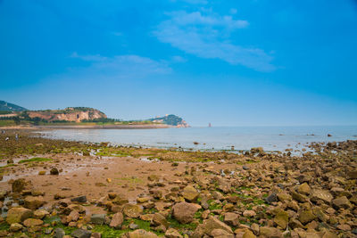 Scenic view of sea against blue sky