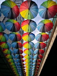 Low angle view of multi colored umbrellas hanging at market stall