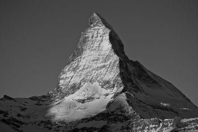 Scenic view of snow covered mountains against sky