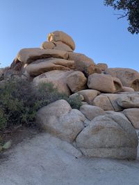 Low angle view of statue against rock formation