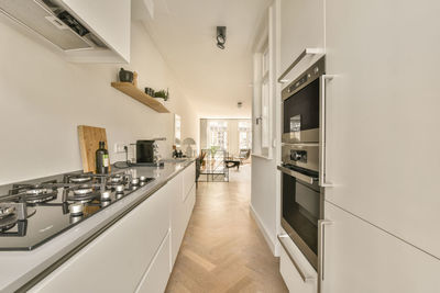 Rear view of woman standing in kitchen