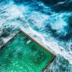 High angle view of infinity pool by sea