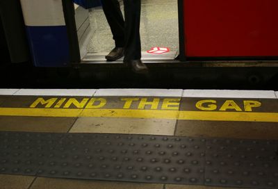 Low section of man standing on bus