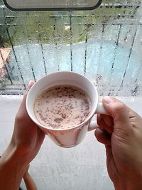 Midsection of person holding coffee cup