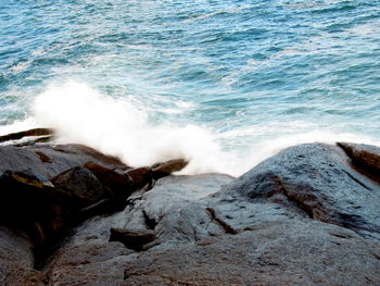 Waves breaking on rocks at shore