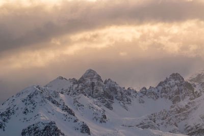 Scenic view of snowcapped mountains against sky during sunset