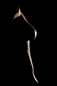 Close-up of a hand over black background