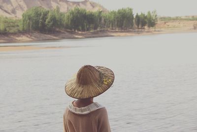 Rear view of woman in sea against sky