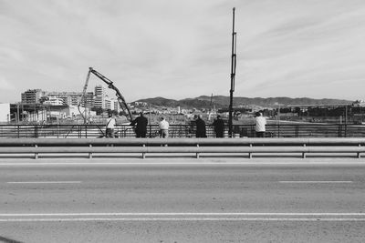 Bridge over road against sky in city