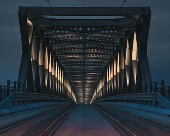 Empty bridge against sky at night