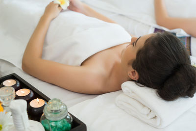 Young woman relaxing on massage table in spa