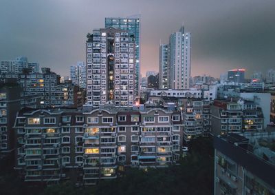 High angle view of illuminated buildings in city against sky
night