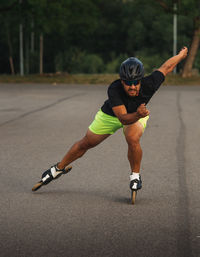 Full length of man inline skating on road