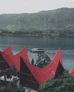 Scenic view of lake by mountains against sky