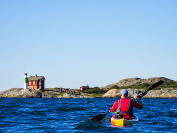 Man kayaking on sea