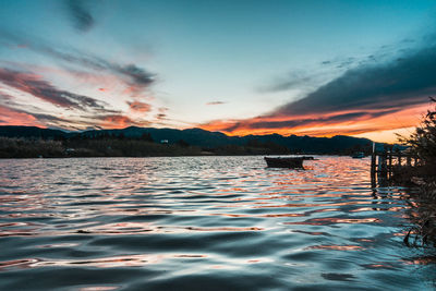 Scenic view of lake against sky during sunset