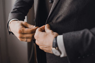 Midsection of man holding hands