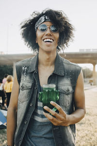 Portrait of smiling young man with jar in music event