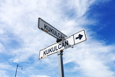 Low angle view of road sign against sky