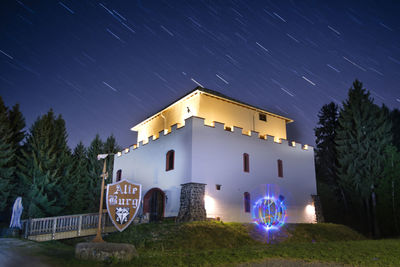 Illuminated building against sky at night