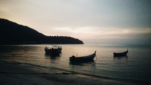 Silhouette of boats at sunset