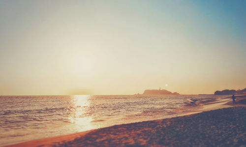 Scenic view of sea against clear sky during sunset