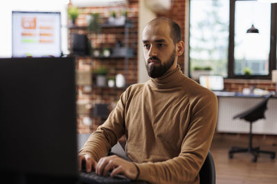 Portrait of young man sitting in cafe