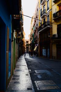 Narrow street amidst buildings in city