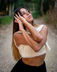 Portrait of beautiful woman standing in park