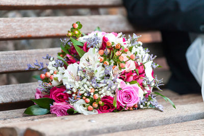 Low section of woman by rose bouquet