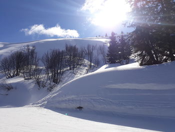 Scenic view of snow covered mountains against sky