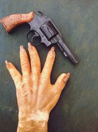 Handgun with artificial hand