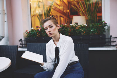 Portrait of young man sitting on sofa