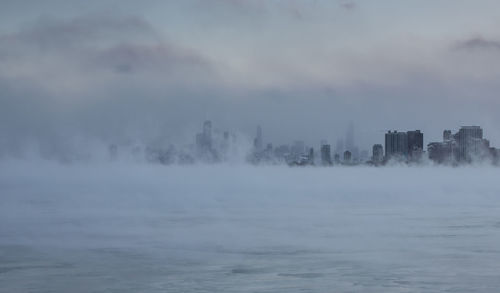 Scenic view of buildings in city against sky