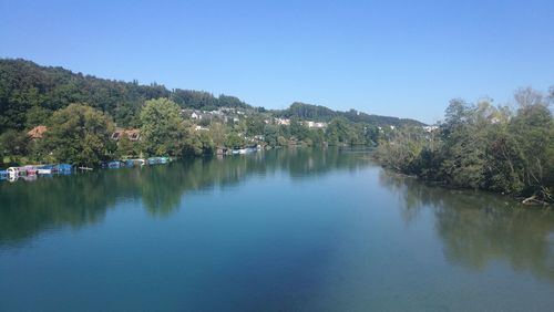 Scenic view of lake against clear blue sky