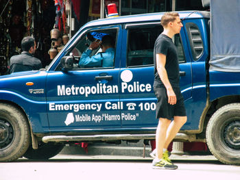 Full length of woman standing on street in city