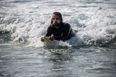 Portrait of smiling man in sea against sky