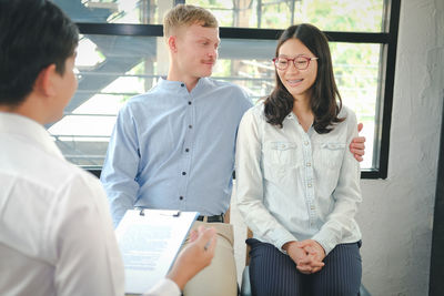 Man looking at woman smiling to health worker