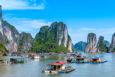 Panoramic view of boats in sea against sky