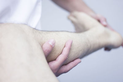 Midsection of doctor examining leg