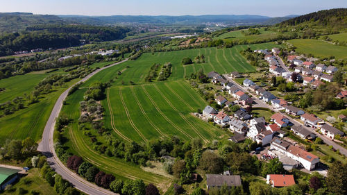 High angle view of trees and buildings in city