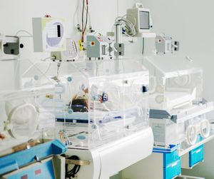 Newborn baby in hospital incubator