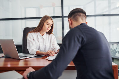 Businesswoman using laptop at office