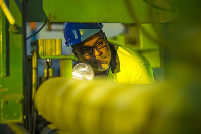 Engineer in industrial plant inspecting machines